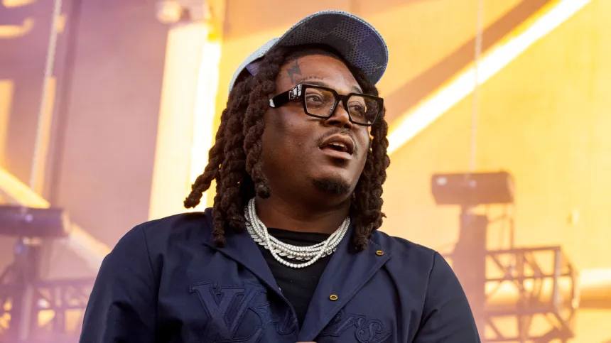 Lucki on stage in glasses and cap