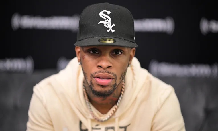 Toosii wearing a Chicago White Sox cap and cream hoodie